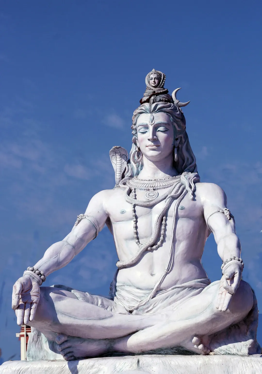 The famous statue of a serene, meditating Lord Shiva on the banks of the Ganges River in Rishikesh, India