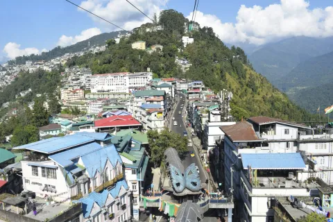 A view from the Gangtok Ropeway, looking down on the colorful cityscape as it spreads across the lush green Himalayan hills