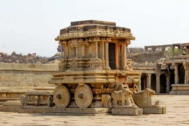 UNESCO World Heritage Site with ancient temples and boulder-strewn landscapes. Explore Virupaksha Temple and Vittala Temple's stone chariot. Safari Sutra Tip: Join our sunrise cycling tour for a magical Hampi experience.