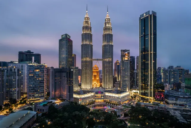 Petronas Towers and street food at Jalan Alor. Safari Sutra Tip: Sunset cocktails with skyline views!
