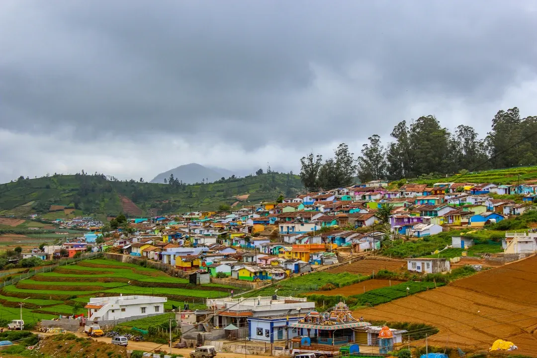 The colorful houses of Poombarai village nestled amongst terraced farms in the hills of Kodaikanal, Tamil Nadu