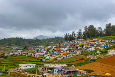 The colorful houses of Poombarai village nestled amongst terraced farms in the hills of Kodaikanal, Tamil Nadu