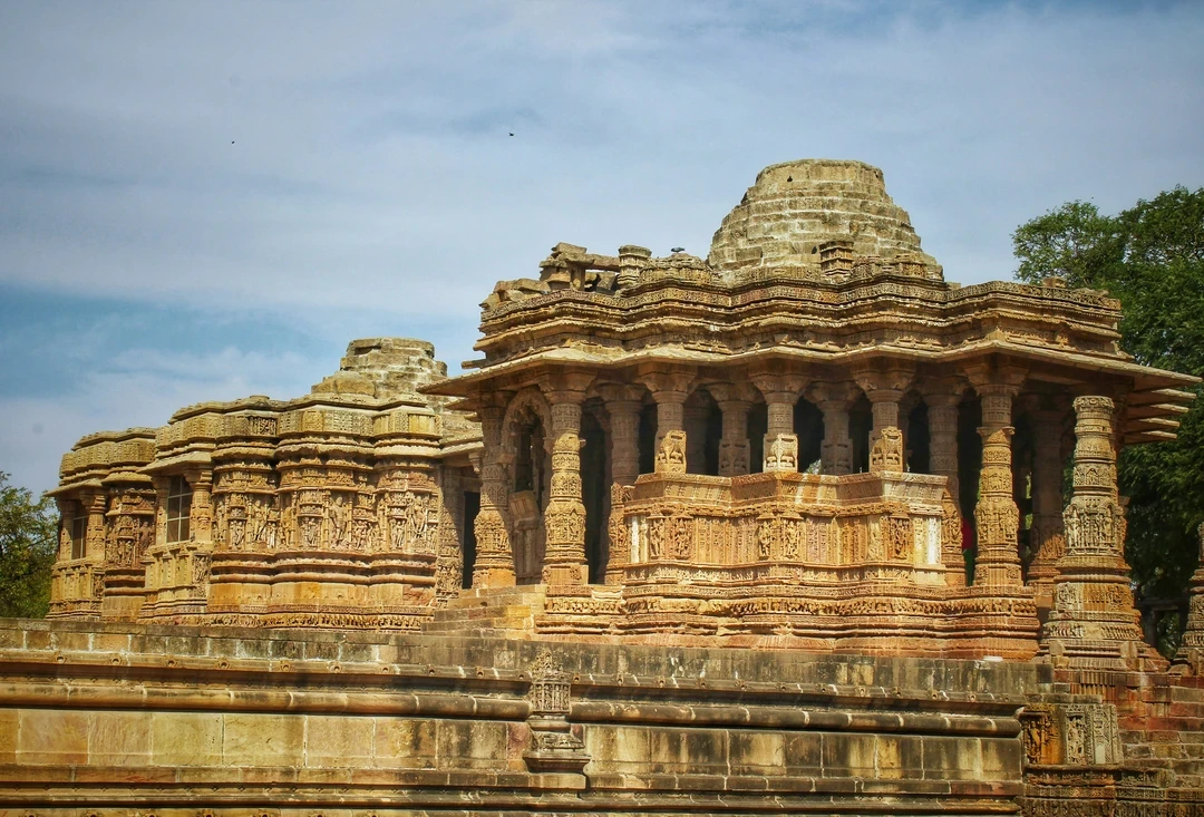 The intricately carved sandstone pillars and walls of the ancient Sun Temple in Modhera, a masterpiece of 11th-century architecture